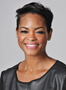 headshot of a female real estate executive in a black camisole and a bright smile