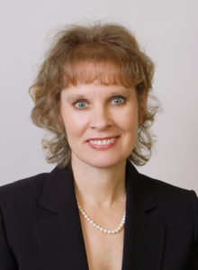 professional headshot of a woman in business suit smiling