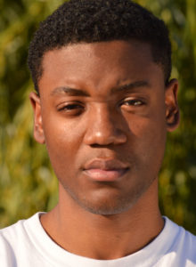 headshot of an actor in dc squinting in the sun