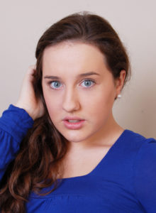 actor headshot of a young girl  looking surpriseed