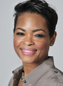 headshot of an executive woman in a casual shirt smiling