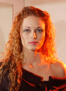 headshot of a curly hair model with lighting effects
