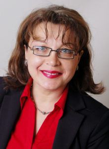 portrait of a russian woman in dark suit and red shirt with a smile