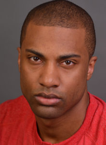 headshot of a young actor in dc in red shirt