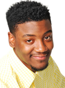 actor headshot of young black man in yellow shirt