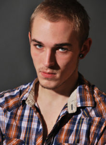 headshot of a male model in checkered shirt looking up