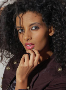 headshot of an ethiopian model with natural makeup 3/4 profile looking at the camera