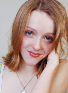 headshot of an aspiring teen model looking candidly at the camera