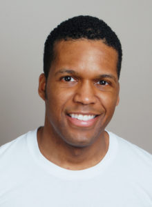 example of actor's headshots: a black man wearing a white t-shirt