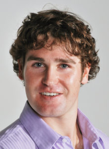sample acting headshot of a white man with lavender shirt looking at the camera