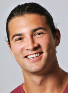 headshot of a male model smiling