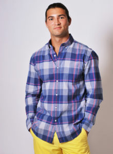picture of a male model wearing a blue checkered shirt and yellow shorts standing