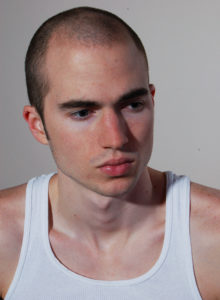 headshot of a male model in pondering mood