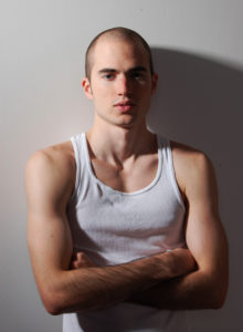 headshot of a male model in dc with body shirt standing