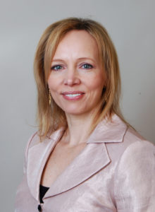 realtor headshot of a female agent from christie's in light pink jacket looking at the camera smiling realtor headshot of a female agent in a classy light pink jacket
