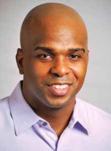 headshot of a young actor in dc with bald head and a nice smile