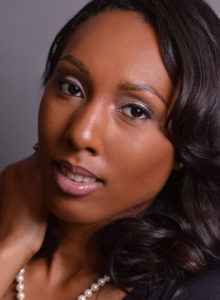 headshot of a model with makeup looking with her head tilted and a hint of a smile