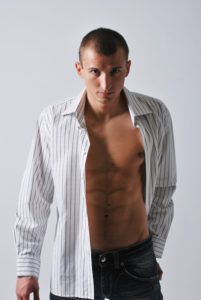 picture of a male model in unbuttoned shirt and split lighting