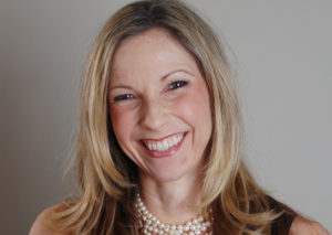 business headshot of a freelance writer with a big smile