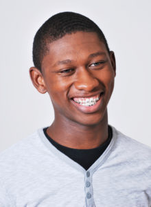actor head shot of a black teen actor smiling