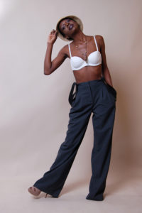 picture of a black model wearing a stylish white bra and a hat