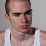 headshot of a male model in pondering mood